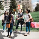 A group young professionals are gathered and chatting in their community.