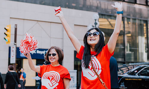 Two United Way employees cheer during Kickoff.