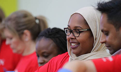 A woman smiles while participating in a Day of Caring®.