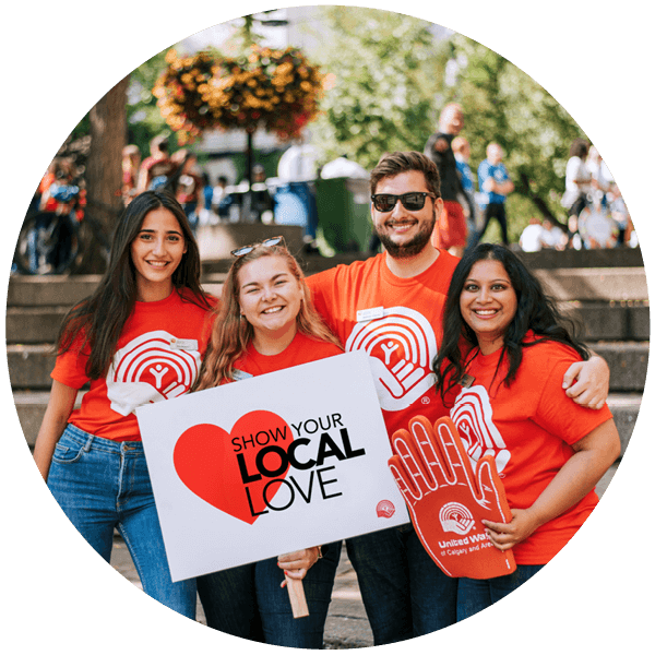 A group of people hold up a sign that reads ``Show Your Local Love``.