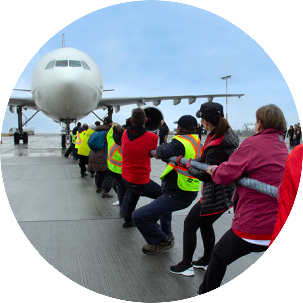 A team pulling a plane.